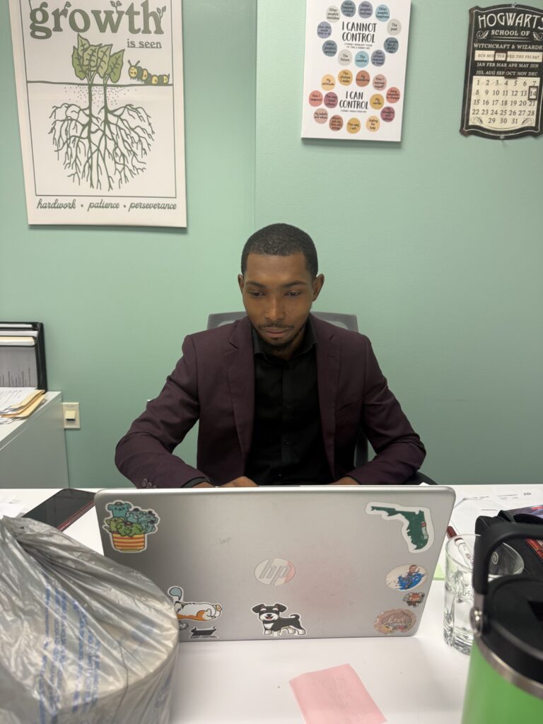 A direct sales professional typing on their laptop